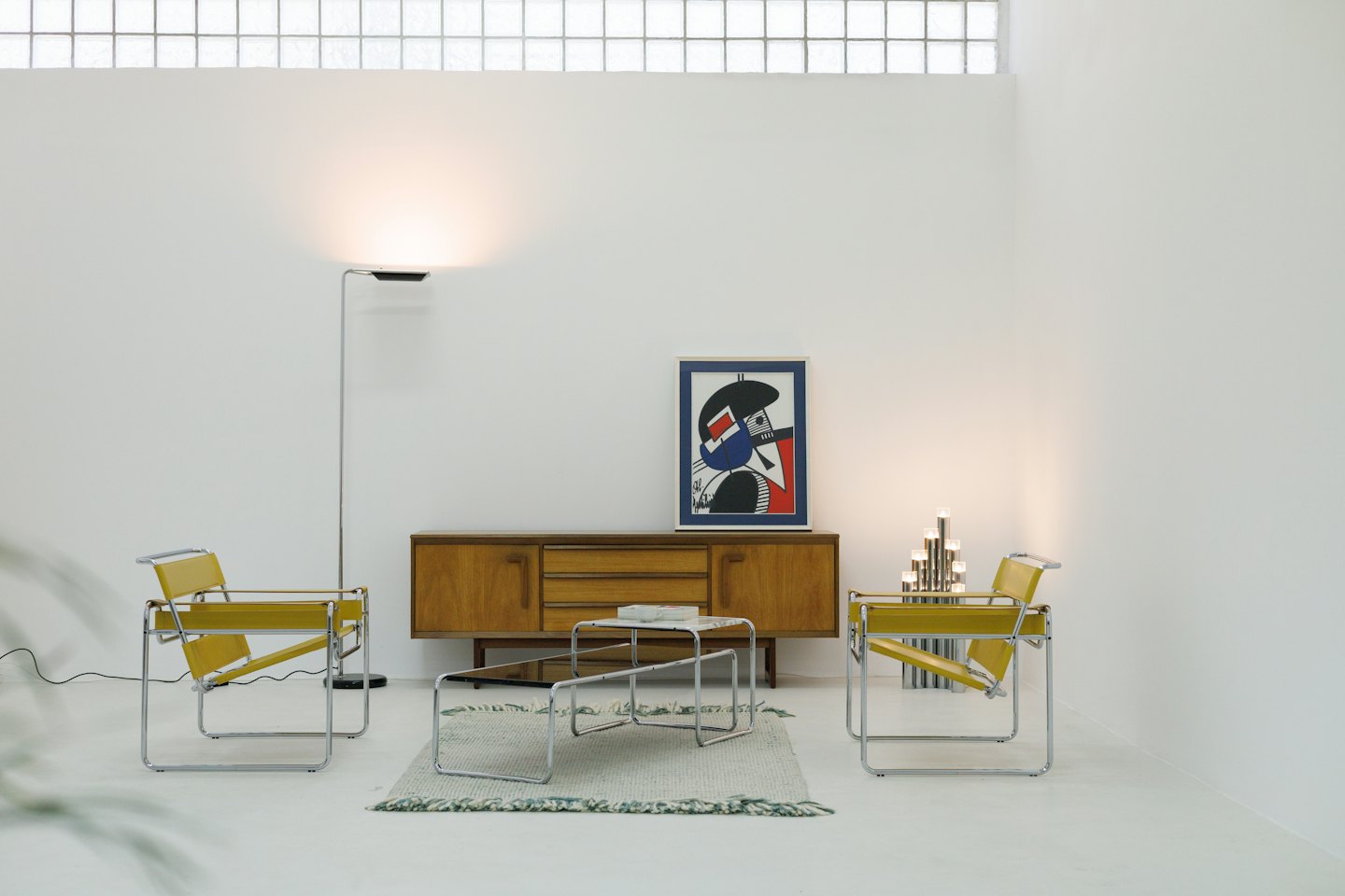 Modern living room with yellow armchairs and abstract art.