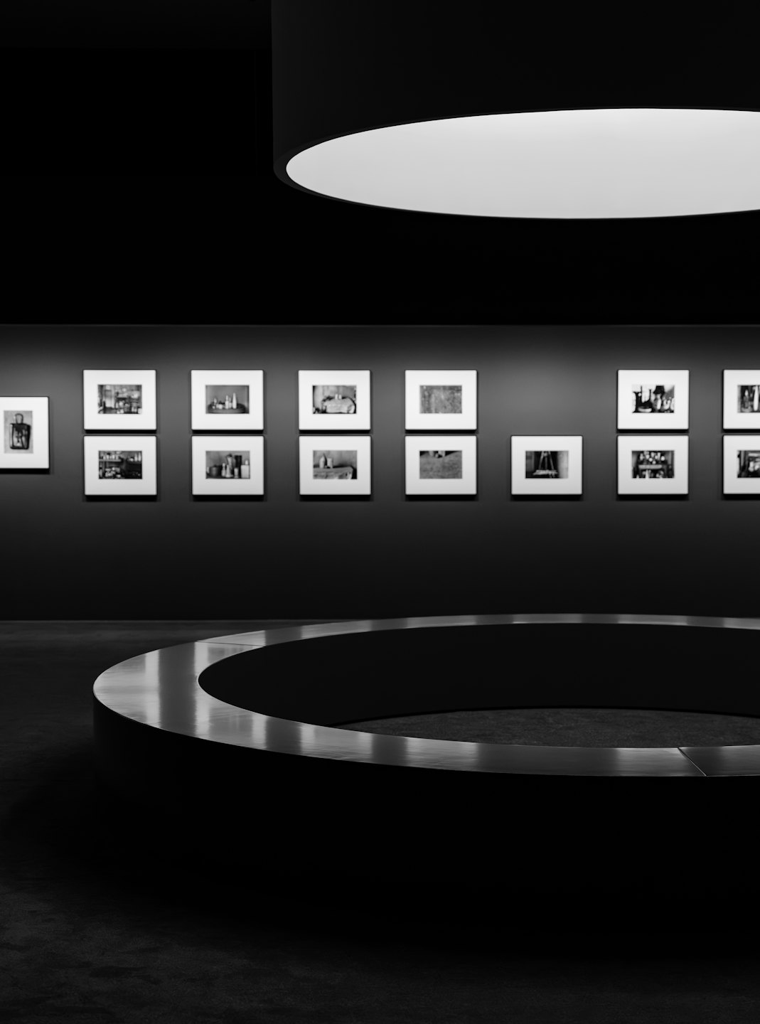 Framed black and white photographs displayed on a gallery wall.